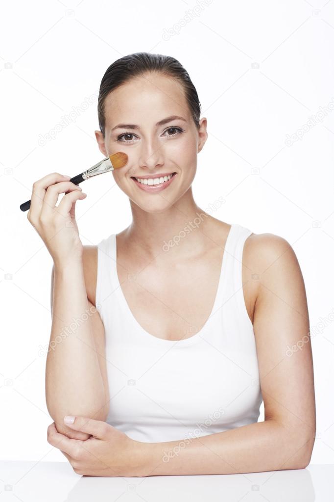 Woman using blusher brush