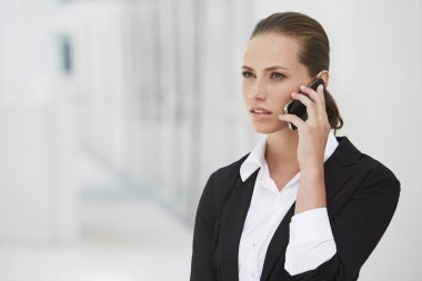 İş kadını cep telefonu kullanıyor.