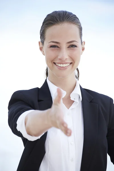 Young businesswoman shaking hand — Stock Photo, Image