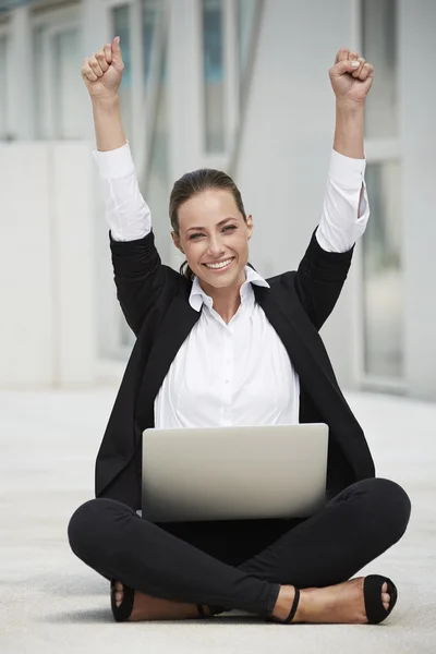 Businesswoman sitting and celebrating — Stock Photo, Image