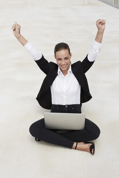 Businesswoman sitting and celebrating — Stock Photo, Image