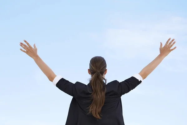 Businesswoman with arms out