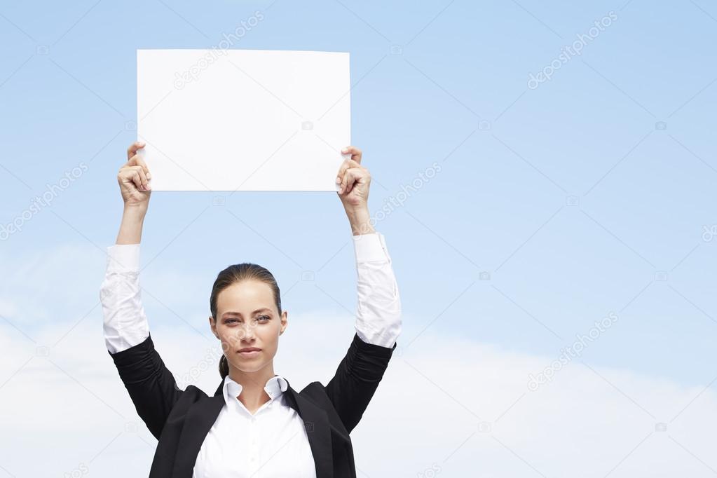 Businesswoman holding blank sign