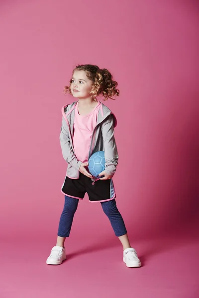 Girl holding football — Stock Photo, Image