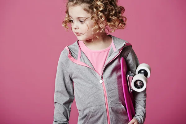 Young girl holding skateboard — Stock Photo, Image