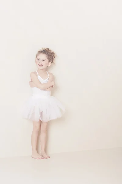 Young ballerina standing in studio — Stock Photo, Image