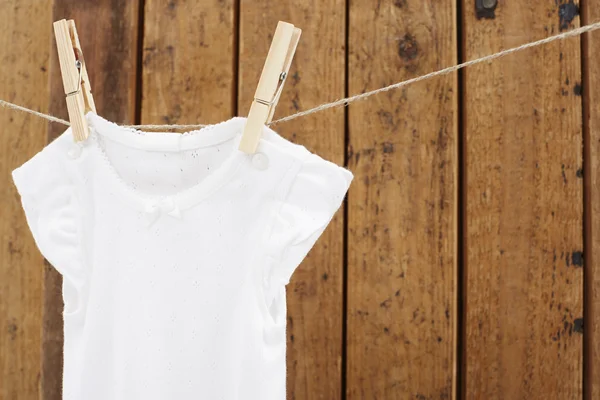 Babygro hanging on washing line — Stock Photo, Image