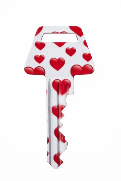 Sleutel bedekt met rode harten — Stockfoto