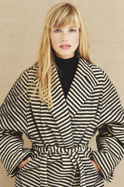 Beautiful model in striped coat — Stock Photo, Image