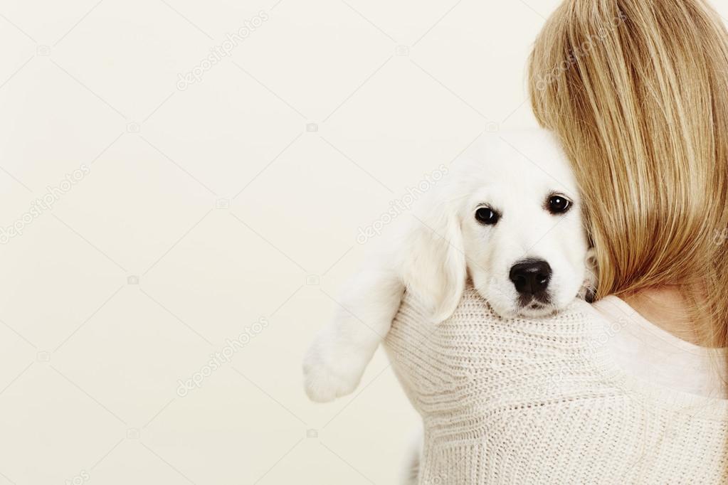 Puppy embraced by blonde owner