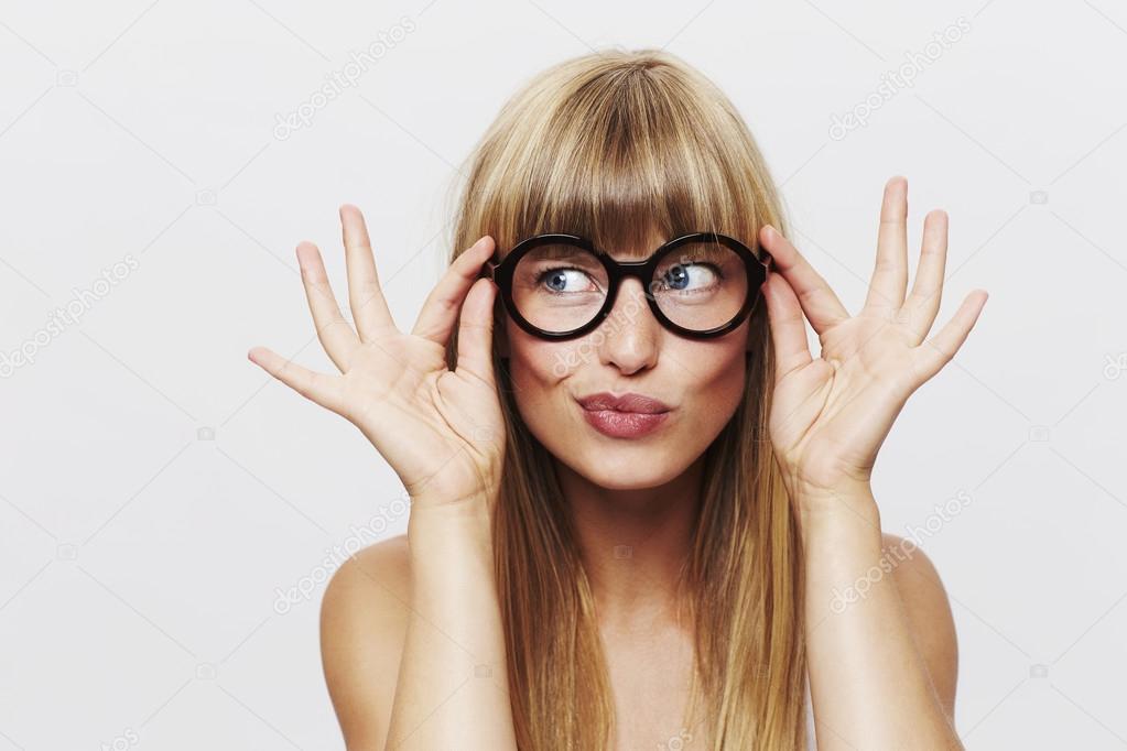 Beautiful woman adjusting spectacles