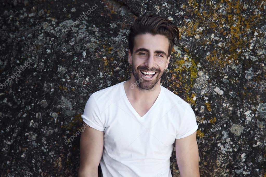 happy young man against rock