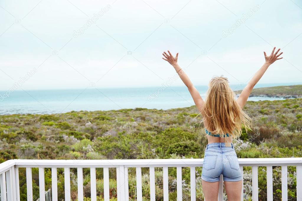Young woman with arms raised