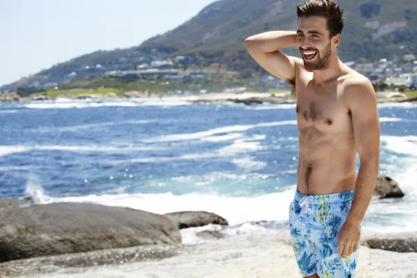 Young man laughing in shorts — Stock Photo, Image