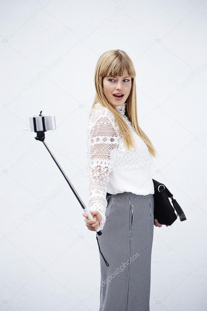 model posing with selfie stick
