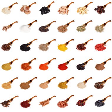 Huge set of spices, dried fruits, nuts, herbs and beans on the wooden spoon isolated on white background. clipart