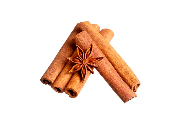 Cinnamon sticks and anise stars on white — Stock Photo, Image