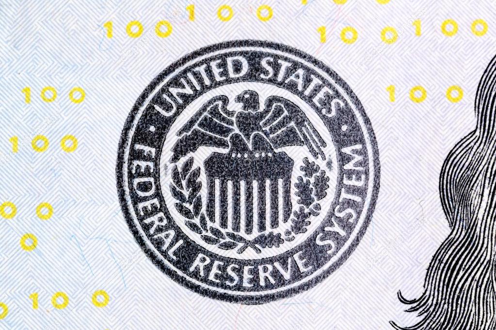 Macro shot of United States Federal Reserve System sign on new 100 dollar bill.