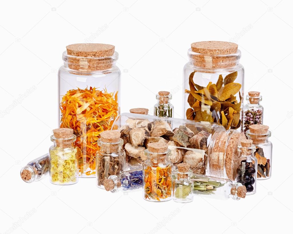Different healing herbs in glass bottles for herbal medicine iso