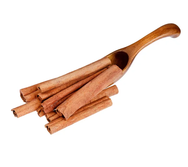 Cinnamon in the wooden spoon, isolated on white background. — Stok fotoğraf