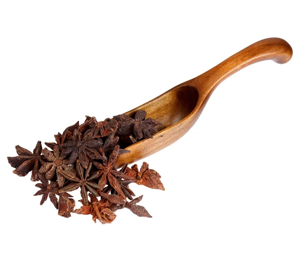 Star anise spice in the wooden spoon, isolated on white backgrou — 图库照片