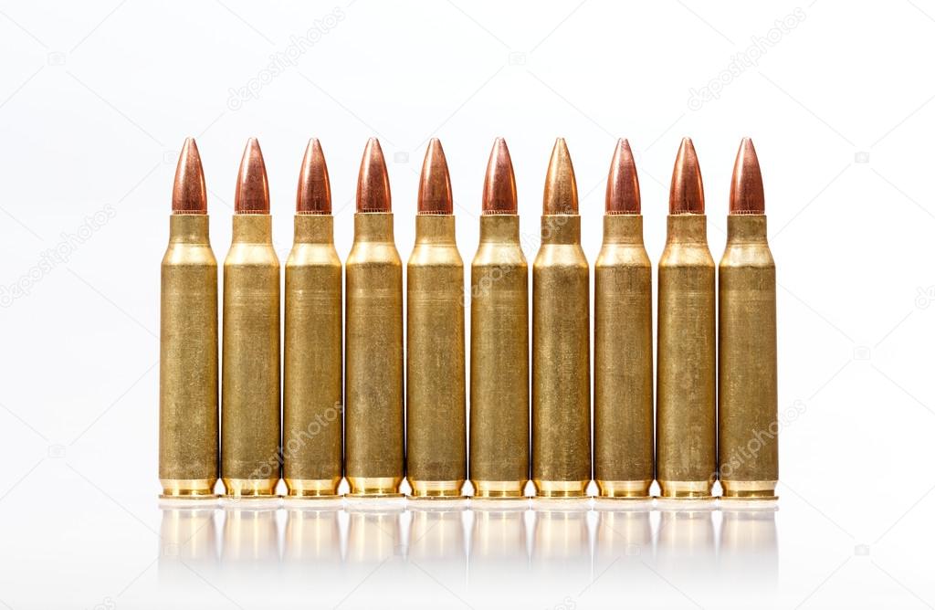 Rifle bullets in a row isolated on white background.