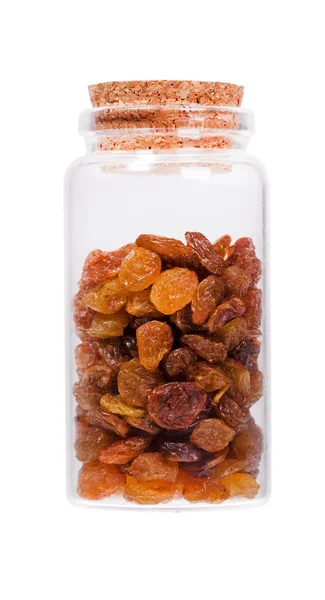 Raisins in a glass bottle with cork stopper, isolated on white. — Stockfoto