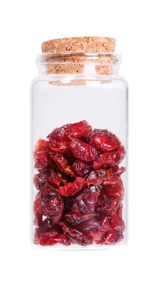 Dried cranberries in a glass bottle with cork stopper, isolated — Stock fotografie