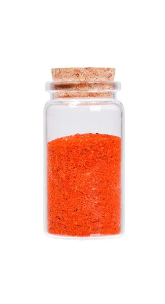 Red chili pepper in a glass bottle with cork stopper, isolated o — Stok fotoğraf