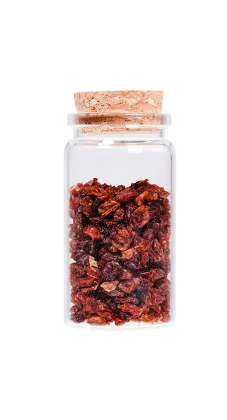 Dried barberries in a glass bottle with cork stopper, isolated o — Stockfoto