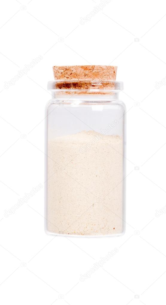 Ground Ginger (Zingiber officinale) in a glass bottle with cork 