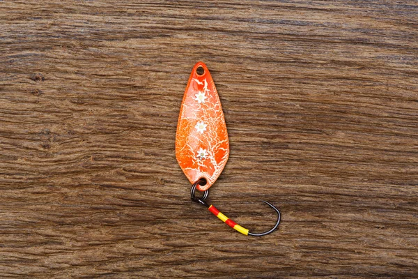 Handcrafted fishing spoon on the old wooden table. — Stock Photo, Image