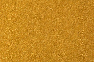 Takdire şayan altın tonunda doymuş parıltı arkaplanı. Yüksek çözünürlüklü fotoğraf.