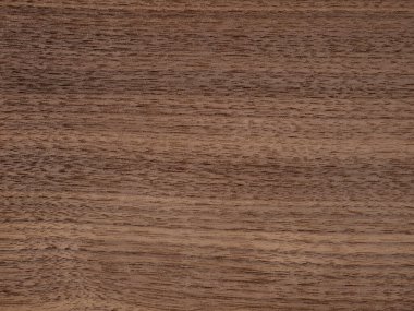 Bu resim, zengin dokuları ve doğal tahıl desenleriyle karakterize edilmiş, lüks tasarım projeleri için sıcaklık ve sofistike bir tasarım sunan, saf bir Canaletto ceviz kaplamasının güzelliğini yakalar.