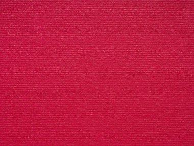 Görüntü kırmızı bir kağıtta dokularla dans eder. Işık ve gölge büyüleyici bir görsel senfoni oluşturmak için sarmalanır.