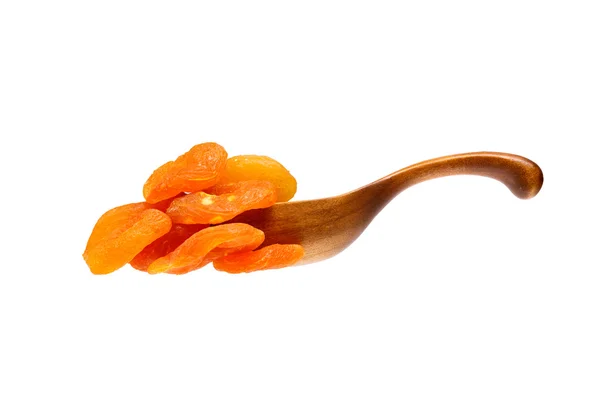 Dried apricots in the wooden spoon, isolated on white background — Stock Photo, Image