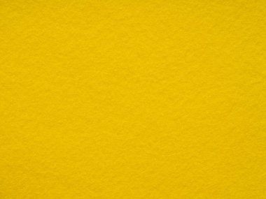 Parlak, sıcak sarı keçeli kumaşın dokusu yakın plan. Tam kare retro, eski model. Noel masaüstü için doymuş arkaplan, yeni yıl tatili, xmas sezonluk dekorasyon, harfler, yamalar