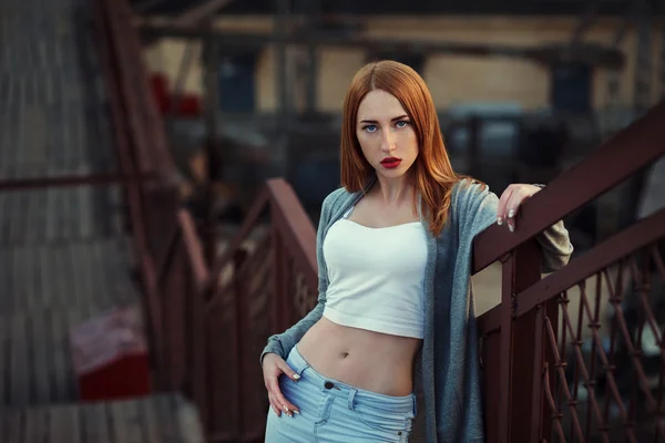 Beautiful redhair young woman in casual closes in urban background. Fashion Photo — Stockfoto