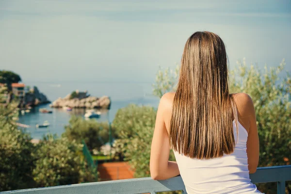 Beautiful young woman looking at the sea. Montenegro, Europe. Toning image. — Stock Photo, Image