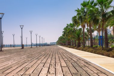 Coastline and promenade in Limassol, island Cyprus, Europe, Mediterranean Sea. Bright sunny day and blue water and sky. clipart