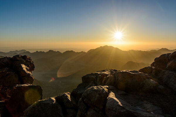 Egypt, Sinai, Mount Moses. View from road on which pilgrims climb the mountain of Moses and dawn - morning sun with rays on the sky.
