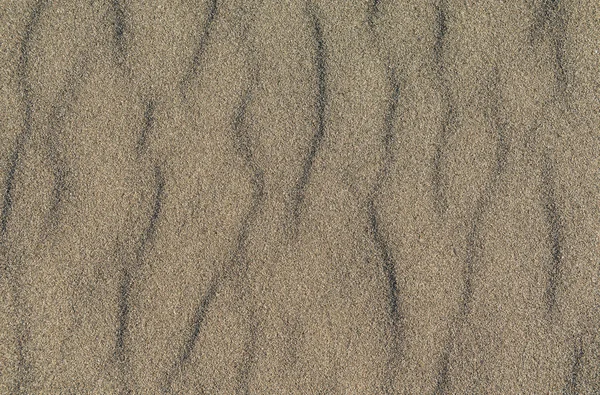 Nahaufnahme von vulkanischem Sand Muster eines Strandes im Sommer — Stockfoto