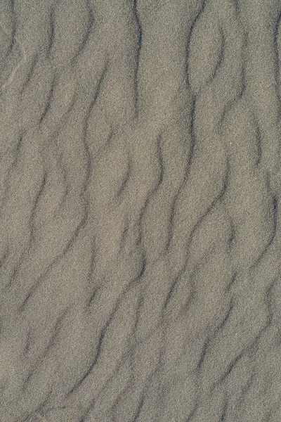 Closeup vzorku vulkanické šedý písek pláže v létě — Stock fotografie