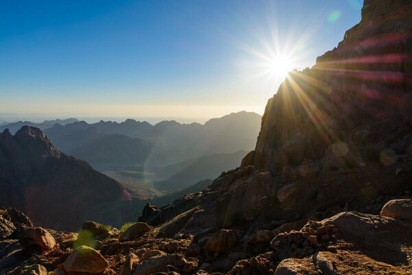 Egypt, Sinai, Mount Moses. View from road on which pilgrims climb the mountain of Moses and dawn - morning sun with rays on the sky.
