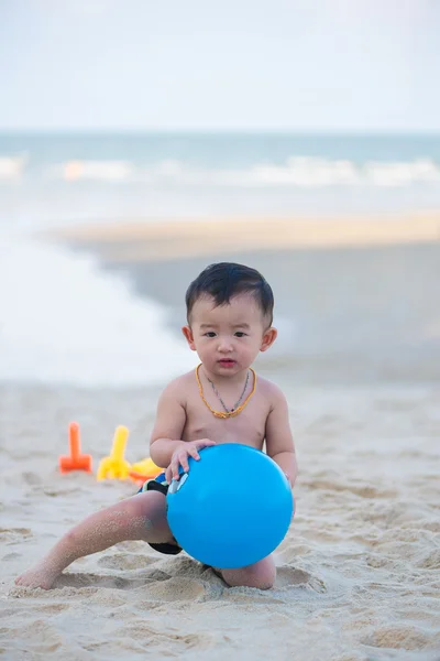 Pequeno menino asiático 1 ano de idade jogando bola na praia — Fotografia de Stock