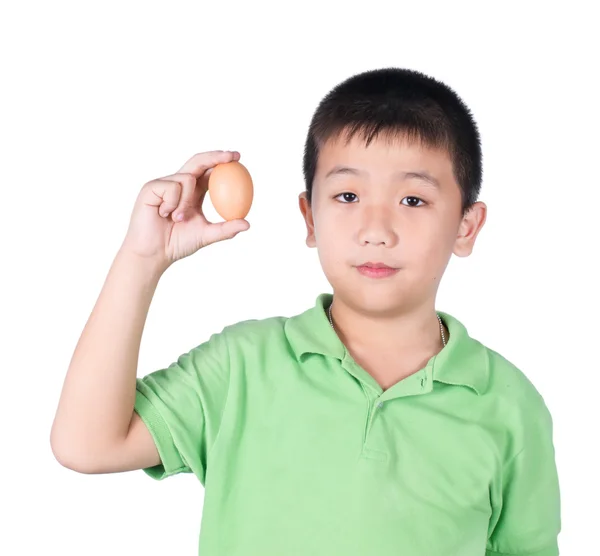 Boy holding hen egg in hand on white background isolated. — Stock Photo, Image