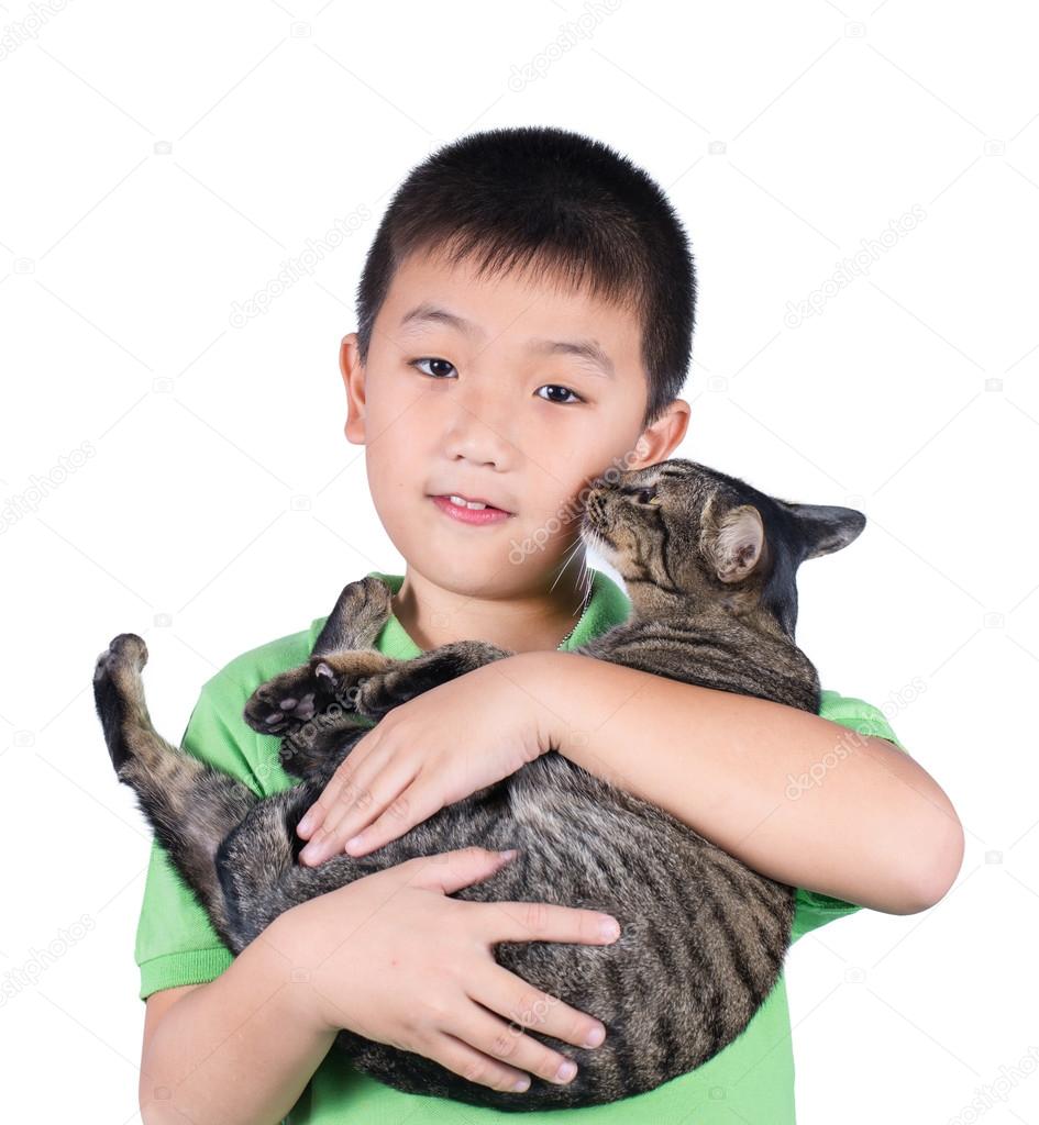 Boy hugging with his cute tiger cat isolated on white background