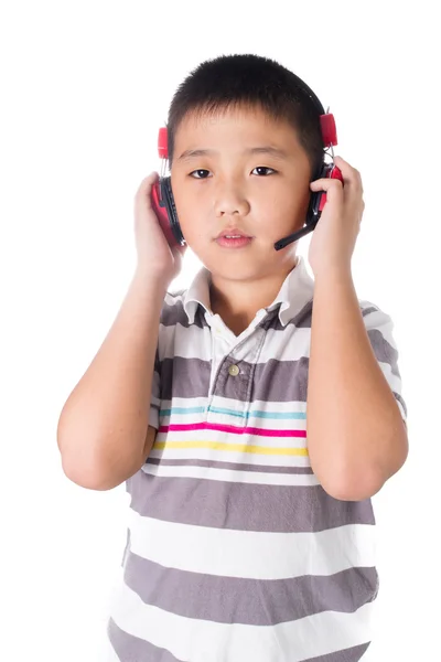Asian boy listening music with headphones, isolated on white background — Stock Photo, Image