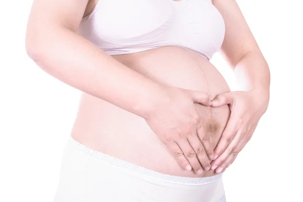 Loving couple with hands around pregnant belly — Stock Photo, Image