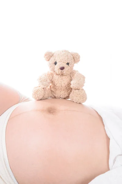 Pregnant woman with hands and have bear doll — Stock Photo, Image